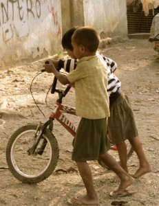 Boys play with a bicycle in Dili, Timor-Leste's capital.